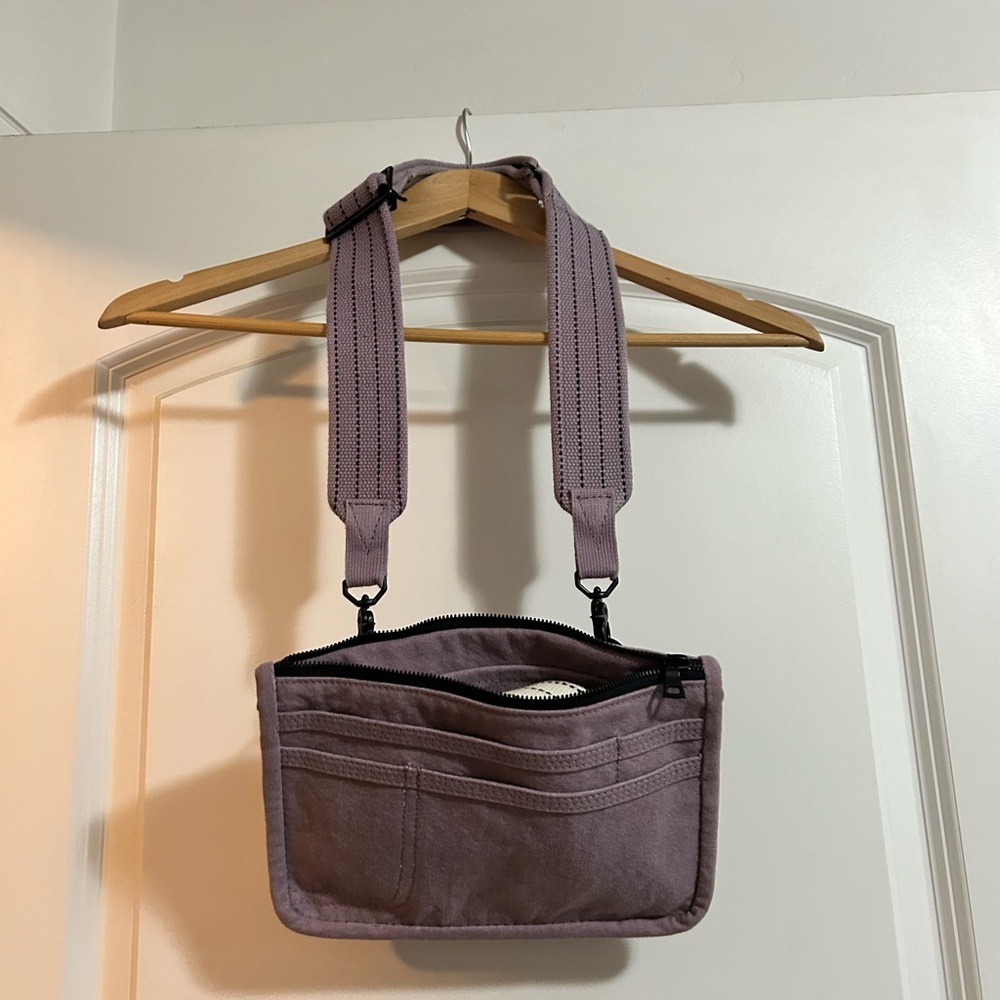 The Particulars convertible pack bag in light‎ purple with extra strap